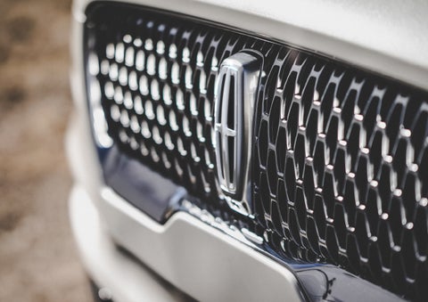 The grille of the 2024 Lincoln Aviator® Reserve model with an eye-catching repeated field of Lincoln Star logo shapes | Gates Ford Lincoln in Richmond KY