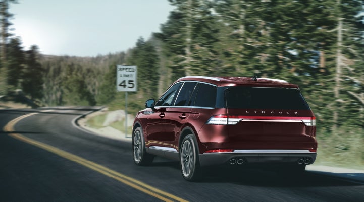 A 2024 Lincoln Aviator® SUV is being driven on a winding mountain road | Gates Ford Lincoln in Richmond KY