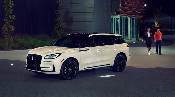 Two people approach a 2024 Lincoln Corsair® SUV featuring the available Jet Appearance Package. | Gates Ford Lincoln in Richmond KY