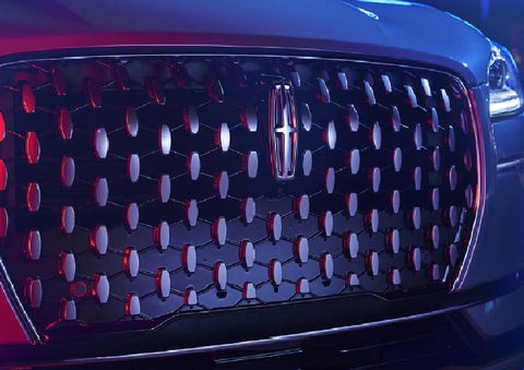 The grille of a 2025 Lincoln Corsair&reg; SUV reflects neon light at night. | Gates Ford Lincoln in Richmond KY