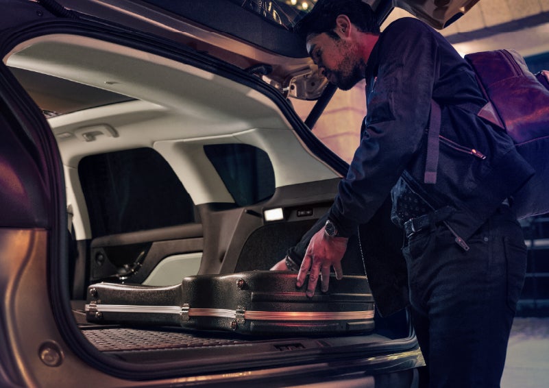 A man is shown loading cargo into the rear of a 2026 Lincoln Corsair® SUV with the second-row seats folded flat. | Gates Ford Lincoln in Richmond KY