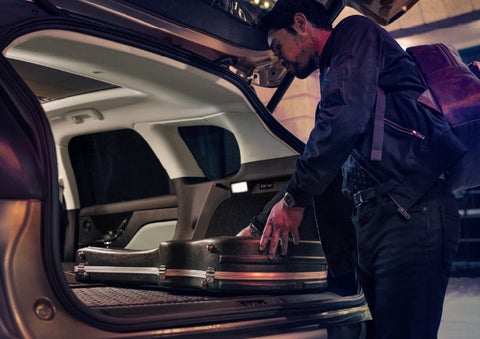 A man is shown loading cargo into the rear of a 2026 Lincoln Corsair® SUV with the second-row seats folded flat. | Gates Ford Lincoln in Richmond KY
