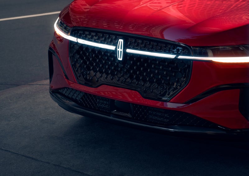 The available front LED light bar and center Lincoln Star logo glow at dusk. | Gates Ford Lincoln in Richmond KY