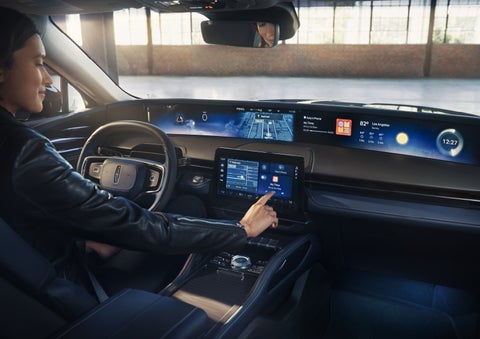 The driver of a 2026 Lincoln Nautilus® SUV interacts with the center touchscreen. | Gates Ford Lincoln in Richmond KY